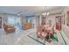 Open-concept living and dining area with hardwood floors and modern furnishings, with a view to the backyard at 4680 Peppertree St, Pahrump, NV 89061