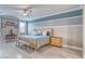 Comfortable bedroom with a wooden bed frame, soft blue bedding, and a ceiling fan at 4680 Peppertree St, Pahrump, NV 89061
