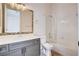 Bathroom featuring a large mirror and white tile shower-tub enclosure at 5148 Villa Vecchio Ct, Las Vegas, NV 89141