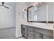 Elegant bathroom features double vanity with gray cabinets and access to bedroom; tile flooring at 5148 Villa Vecchio Ct, Las Vegas, NV 89141