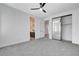 Spacious bedroom with ceiling fan, mirrored closet, and an ensuite bathroom at 5148 Villa Vecchio Ct, Las Vegas, NV 89141