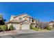 Charming two-story home showcasing manicured landscaping and a three-car garage at 5148 Villa Vecchio Ct, Las Vegas, NV 89141