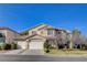 Charming two-story home showcasing manicured landscaping and a three-car garage at 5148 Villa Vecchio Ct, Las Vegas, NV 89141