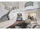 Grand foyer showcasing a curved staircase, high ceilings, and elegant chandelier at 5148 Villa Vecchio Ct, Las Vegas, NV 89141