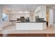 Open kitchen featuring white cabinetry, dark countertops, and modern light fixtures at 5148 Villa Vecchio Ct, Las Vegas, NV 89141