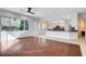 Open living area with large windows and views of the modern kitchen, seamlessly connecting living spaces at 5148 Villa Vecchio Ct, Las Vegas, NV 89141