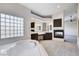 Bright main bathroom with a soaking tub, vanity, fireplace and glass block window at 5148 Villa Vecchio Ct, Las Vegas, NV 89141