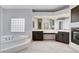 Spacious main bathroom featuring a large soaking tub, dual sinks, and a fireplace at 5148 Villa Vecchio Ct, Las Vegas, NV 89141