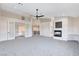 Open main bedroom with a fireplace and a view of the upper story balcony and staircase at 5148 Villa Vecchio Ct, Las Vegas, NV 89141