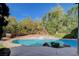 Inviting backyard pool with stone coping and lush landscaping at 5148 Villa Vecchio Ct, Las Vegas, NV 89141
