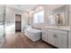 Beautiful bathroom featuring a soaking tub, double sink vanity, tile flooring, and a glass-enclosed shower at 5371 Brevin Ct, Las Vegas, NV 89131