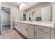 Bathroom with double sinks, quartz countertop, and large mirror at 5371 Brevin Ct, Las Vegas, NV 89131
