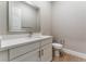 Clean half bathroom features a large mirror, modern vanity, and a tiled floor at 5371 Brevin Ct, Las Vegas, NV 89131