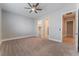 Spacious bedroom features a ceiling fan, carpeted floor, and a view of a walk-in closet and bathroom at 5371 Brevin Ct, Las Vegas, NV 89131