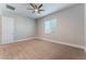 Neutral bedroom with a ceiling fan and carpeted floors at 5371 Brevin Ct, Las Vegas, NV 89131