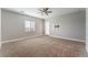 Spacious bedroom with carpet flooring, ceiling fan, and natural light at 5371 Brevin Ct, Las Vegas, NV 89131