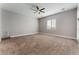 Large bedroom with ceiling fan, window, and carpet flooring at 5371 Brevin Ct, Las Vegas, NV 89131