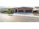 Inviting single-story home with a 3 car garage, stone accents, and desert landscaping at 5371 Brevin Ct, Las Vegas, NV 89131