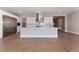 Modern kitchen with stainless steel appliances, a center island, and views to the living space at 5371 Brevin Ct, Las Vegas, NV 89131