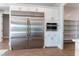 Modern kitchen with stainless steel appliances, custom white cabinets, and a spacious pantry area at 5371 Brevin Ct, Las Vegas, NV 89131