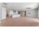 Open-concept living room boasts hardwood floors, recessed lighting, and a modern kitchen with a large island at 5371 Brevin Ct, Las Vegas, NV 89131