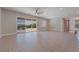 Open living room with tile flooring and access to outdoor living area with fireplace at 5371 Brevin Ct, Las Vegas, NV 89131