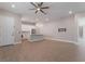 Open-concept living area with kitchen, hardwood floors, and a ceiling fan, perfect for entertaining at 5371 Brevin Ct, Las Vegas, NV 89131