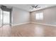 Bright, spacious living room featuring hardwood floors, a ceiling fan, and ample natural light from a window at 5371 Brevin Ct, Las Vegas, NV 89131