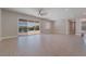 Bright living room featuring tile floors, a ceiling fan, and access to the outdoor space through sliding glass doors at 5371 Brevin Ct, Las Vegas, NV 89131