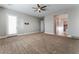 Spacious main bedroom with neutral tones, carpet flooring, ceiling fan, and adjoining bathroom with walk-in closet at 5371 Brevin Ct, Las Vegas, NV 89131