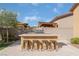 Outdoor kitchen with stainless steel grill and bar seating, perfect for entertaining and outdoor dining at 5371 Brevin Ct, Las Vegas, NV 89131