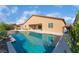 Sparkling pool with a Baja shelf, lush landscaping, and a covered patio in the backyard at 5371 Brevin Ct, Las Vegas, NV 89131