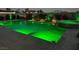 Backyard pool featuring radiant green underwater lighting, enhancing the outdoor living space at 5371 Brevin Ct, Las Vegas, NV 89131