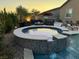 Backyard pool and spa with inset seating next to an outdoor kitchen and seating area at 5371 Brevin Ct, Las Vegas, NV 89131