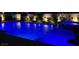 Backyard pool with blue underwater lights and adjacent spa, creating a serene nighttime ambiance at 5371 Brevin Ct, Las Vegas, NV 89131
