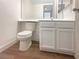Compact bathroom featuring clean lines, laminate floors, and efficient space utilization at 5383 Mountain Vista St # 20, Las Vegas, NV 89120