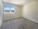 Minimalist bedroom with neutral walls, plush carpet, and a bright window, creating a peaceful and calming space at 5383 Mountain Vista St # 20, Las Vegas, NV 89120