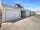 Carport features an enclosed parking space with white door and concrete driveway, providing secure parking at 5383 Mountain Vista St # 20, Las Vegas, NV 89120
