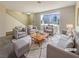 Bright living room with cozy seating arrangement, large window, and neutral decor, ideal for relaxation and entertaining at 5383 Mountain Vista St # 20, Las Vegas, NV 89120