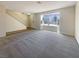 Spacious living room with plush carpet, a large window, and neutral paint, creating a versatile and welcoming atmosphere at 5383 Mountain Vista St # 20, Las Vegas, NV 89120