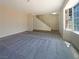 Bright, spacious living room with carpet flooring and staircase access to other level at 5383 Mountain Vista St # 20, Las Vegas, NV 89120