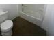 Bathroom featuring white walls, tub, and toilet at 5580 E Carey Ave, Las Vegas, NV 89156