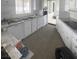 White kitchen featuring light countertops, white cabinets, and wood-look floors at 5580 E Carey Ave, Las Vegas, NV 89156