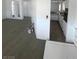Open concept living room leading into the kitchen featuring all-white paint and trim at 5580 E Carey Ave, Las Vegas, NV 89156