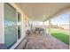 Covered patio that extends from the home to the landscaped backyard featuring artificial turf and desert accents at 6225 Gambetta St, Las Vegas, NV 89115
