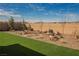 Low maintenance backyard features beautiful desert landscaping, artificial grass and a charming rock garden at 6225 Gambetta St, Las Vegas, NV 89115