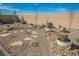 Low maintenance backyard with rock landscaping, stepping stones, and potted plants, enclosed by a block wall at 6225 Gambetta St, Las Vegas, NV 89115