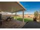 A covered patio with brick pavers leads to a manicured backyard, boasting artificial turf and desert landscaping at 6225 Gambetta St, Las Vegas, NV 89115