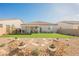 Expansive backyard with lush artificial turf and desert landscaping that creates a serene retreat with easy maintenance at 6225 Gambetta St, Las Vegas, NV 89115