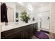 Modern bathroom features dual sinks, granite countertops, walk-in shower and wood look flooring at 6225 Gambetta St, Las Vegas, NV 89115